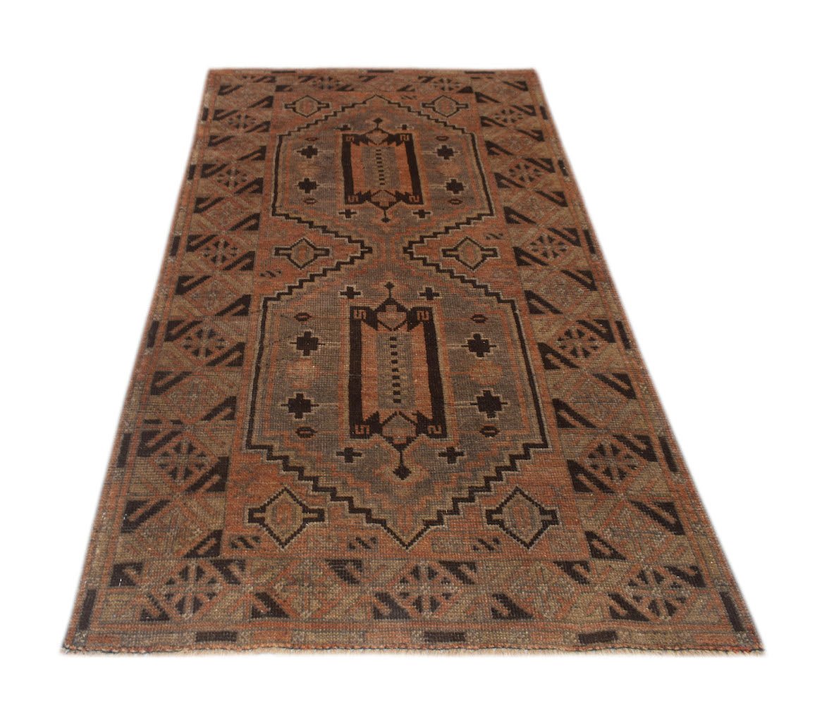 Handmade Afghan Baluch rug featuring a geometric pattern in shades of brown and rust.
