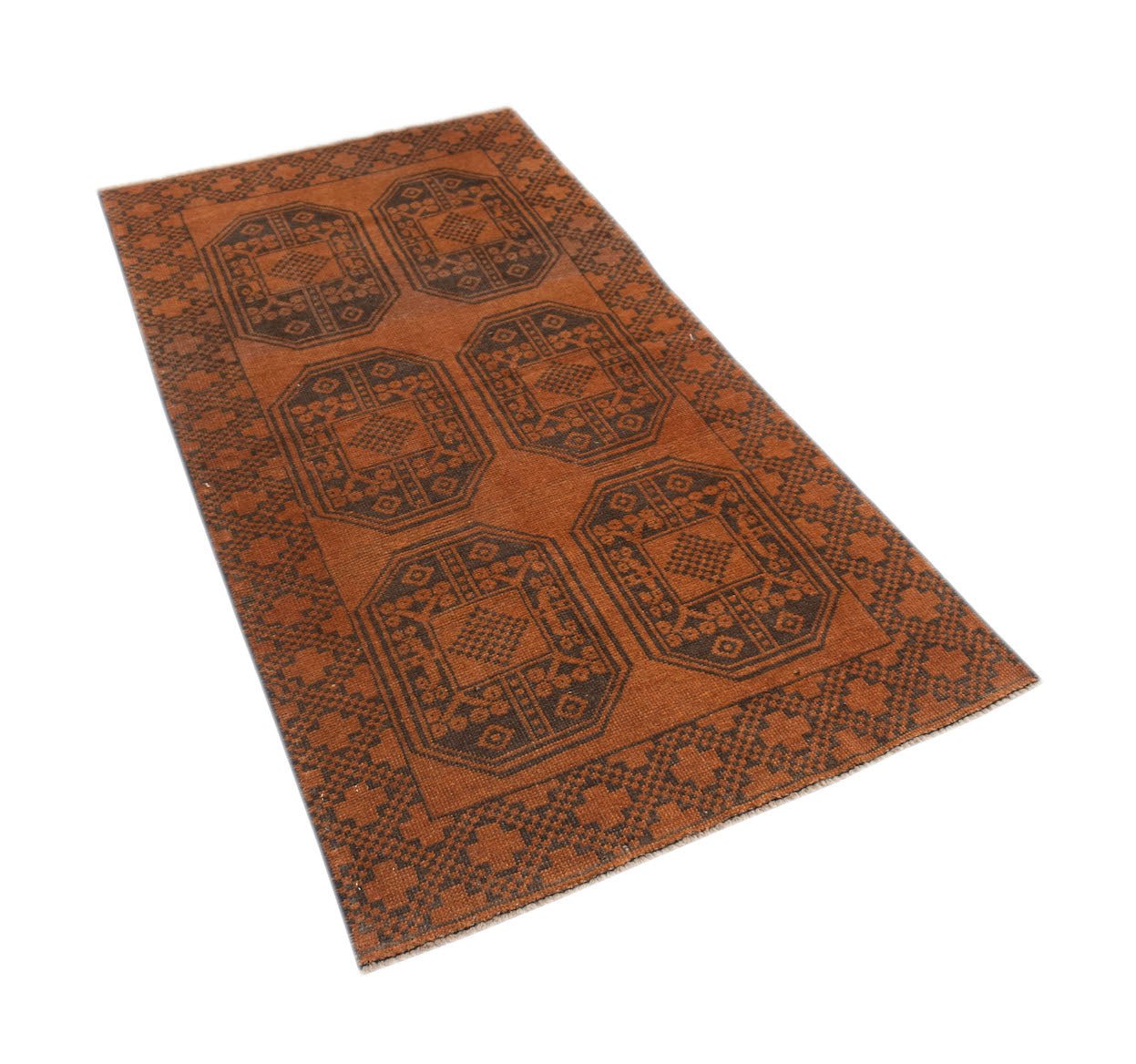 A handmade Afghan Baluch rug featuring a repeating geometric medallion pattern in shades of brown.