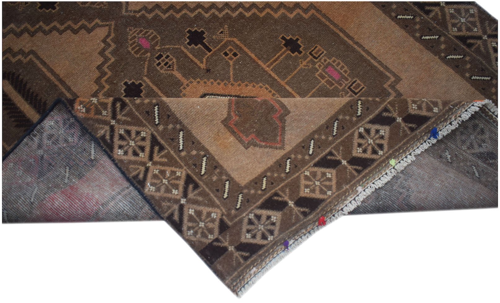 A handmade Afghan Baluch rug with a brown geometric pattern and a folded corner.