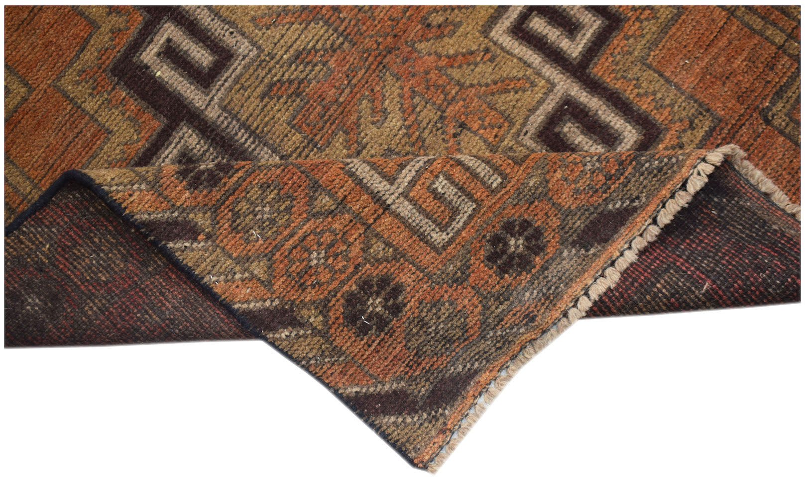 An Afghan Baluch rug with a geometric pattern in shades of orange, brown, and tan.