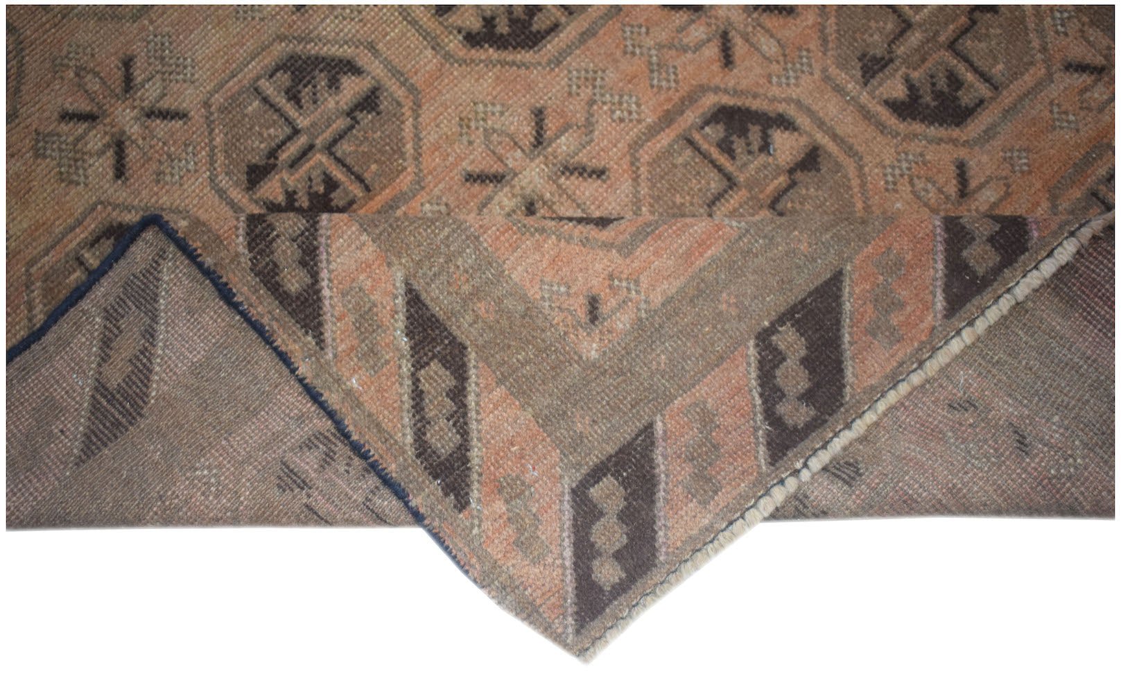 A handmade Afghan Baluch rug with geometric patterns in shades of brown and peach.