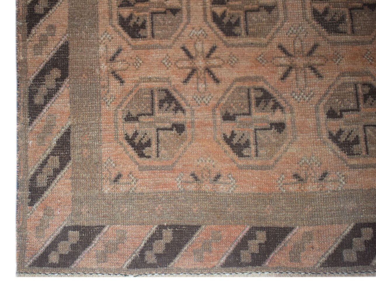 Handmade Afghan Baluch rug featuring geometric octagonal motifs in brown and terracotta tones.