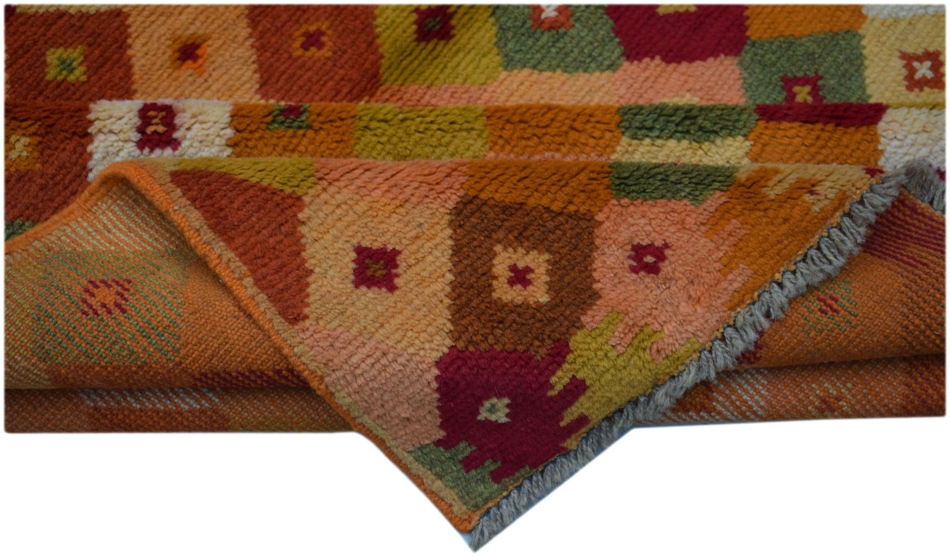 Handmade Afghan Baluch rug featuring a colorful geometric patchwork pattern in wool.