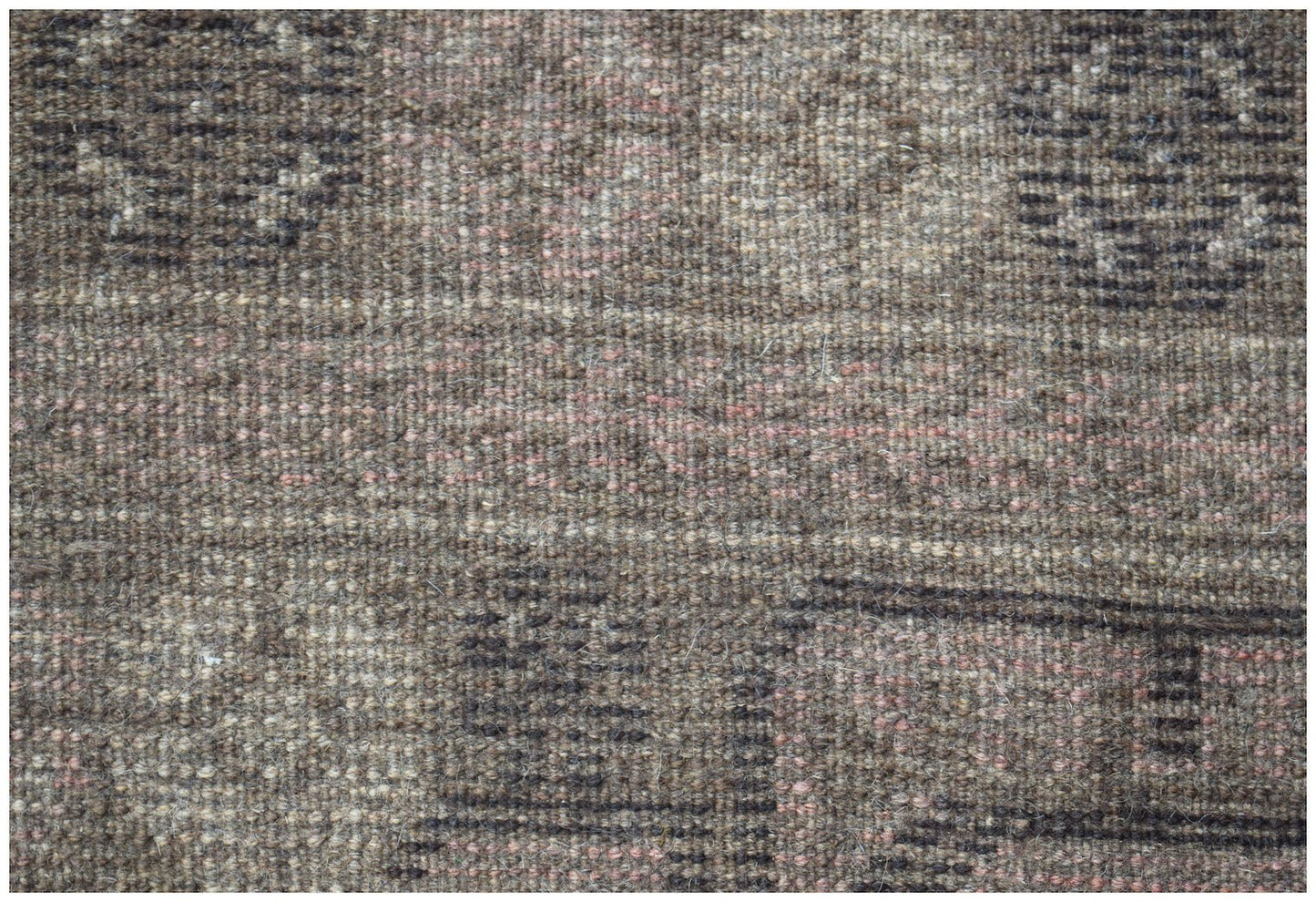 A handmade Afghan Baluch wool rug featuring a dark brown geometric pattern with subtle pink accents.