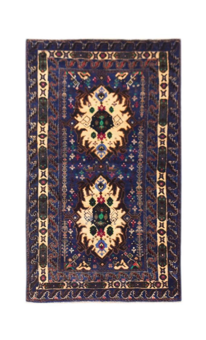 A vintage handmade Afghan Baluch rug featuring two cream medallions on a deep blue field.
