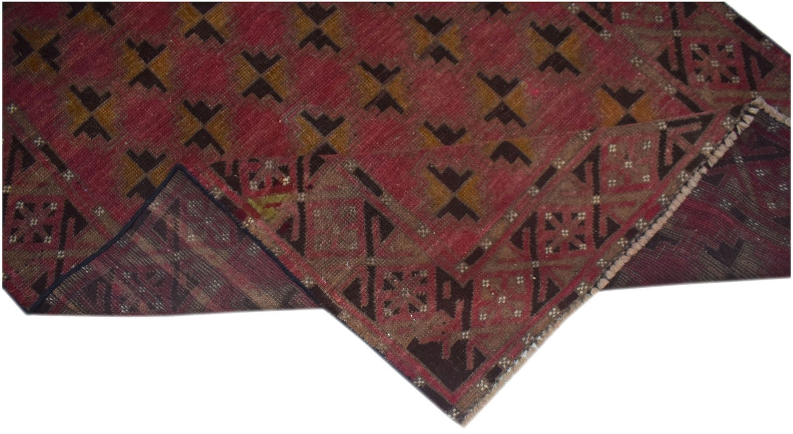 A handmade Afghan Baluch rug featuring a red field with geometric patterns and a dark border.