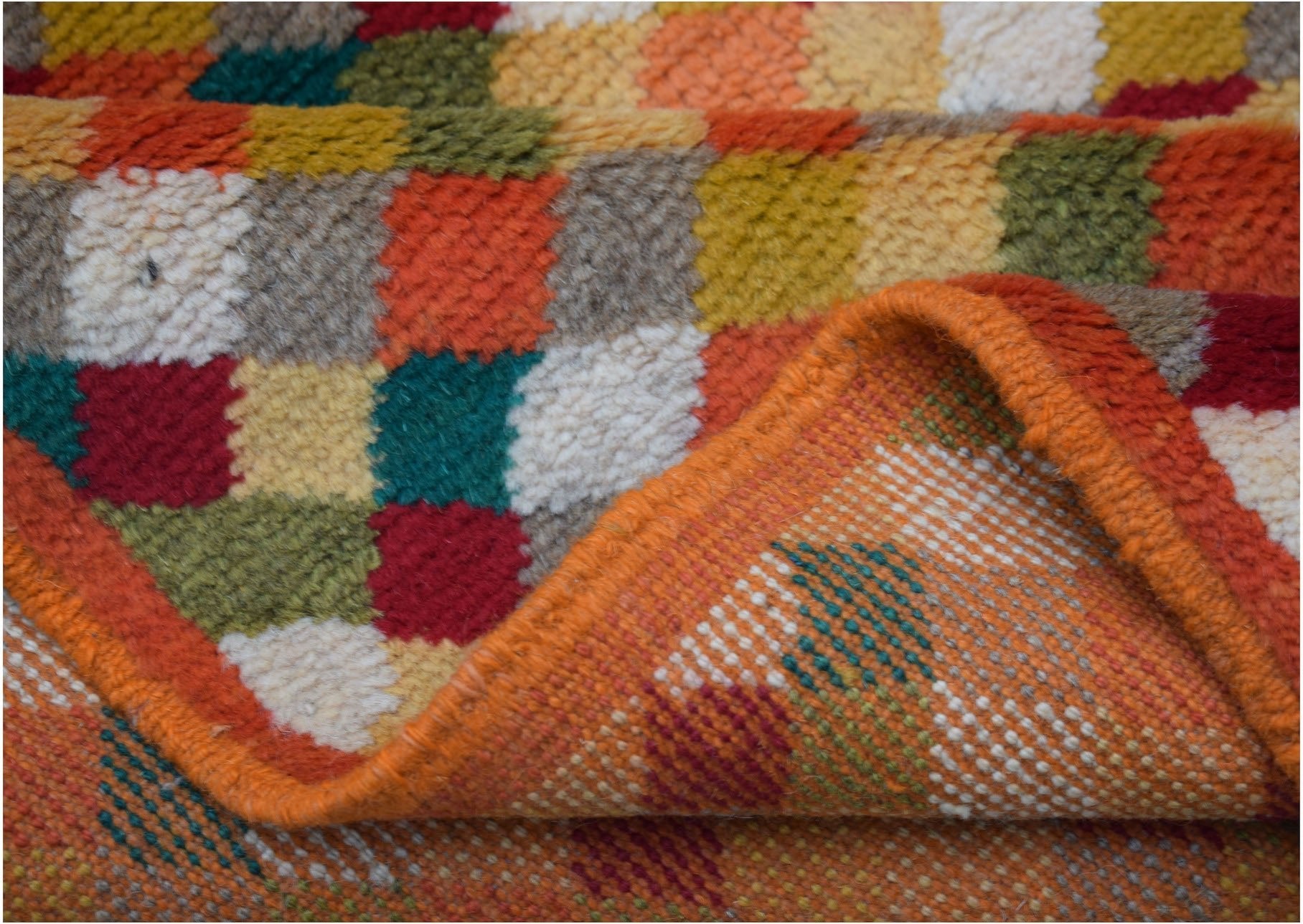 A handmade Afghan Baluch rug featuring a colorful checkered pattern in wool.