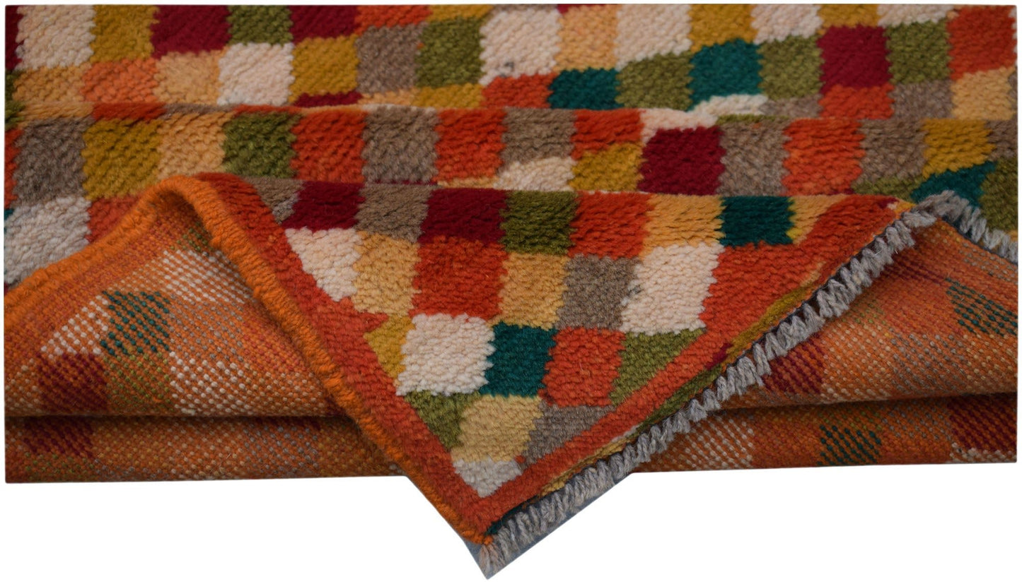 A handmade Afghan Baluch rug featuring a colorful checkered pattern in wool.