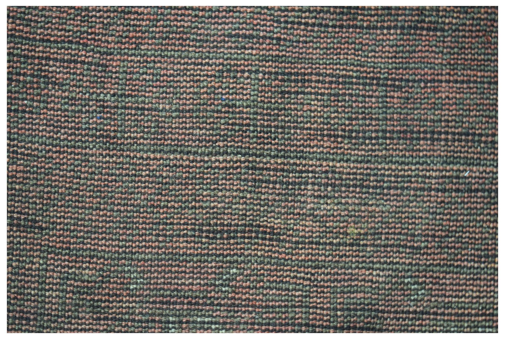 A handmade Afghan Baluch rug featuring a textured, horizontal striped pattern in earthy tones.
