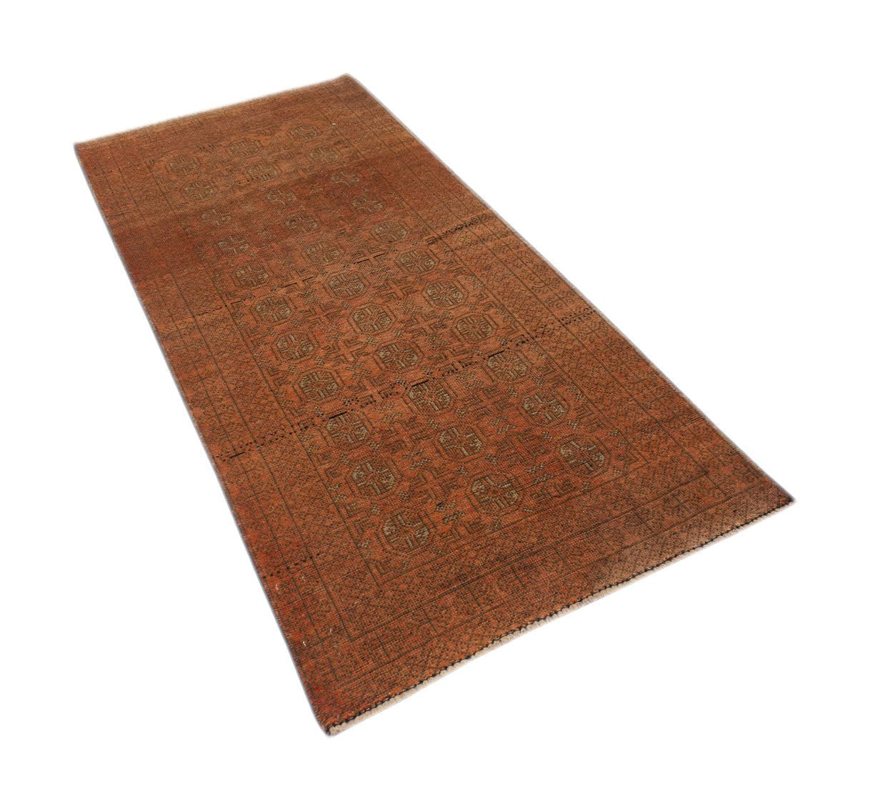 A rectangular handmade Afghan Baluch rug featuring a repeating geometric pattern in rust tones.