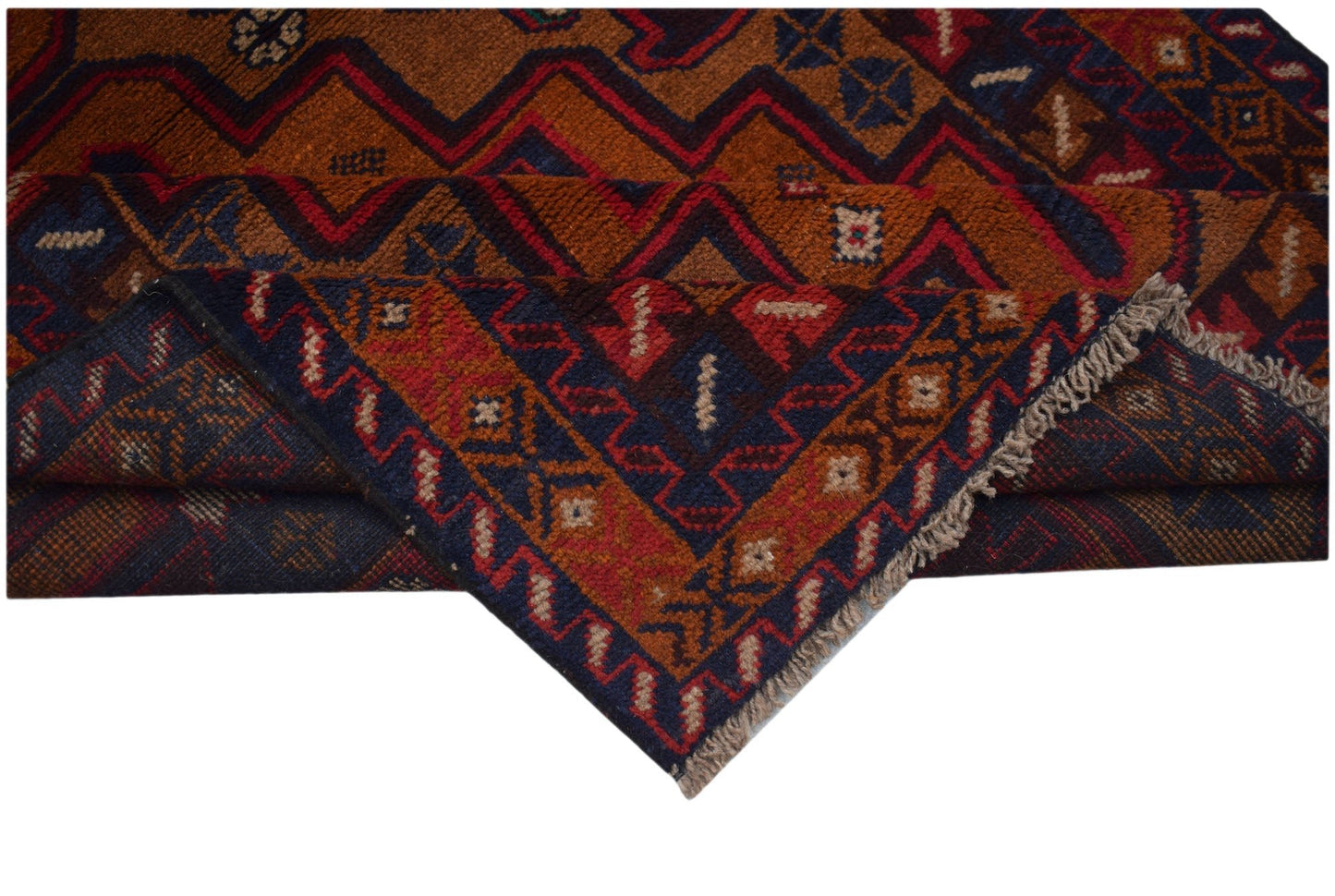 Handmade Afghan Baluch rug featuring geometric patterns in deep red, brown, and blue wool.
