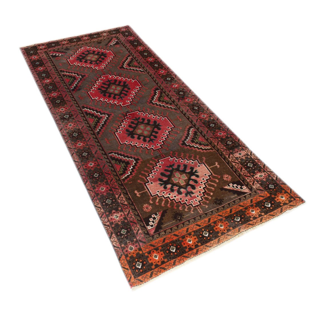 A handmade Afghan Baluch runner rug featuring geometric medallions in red and brown tones.
