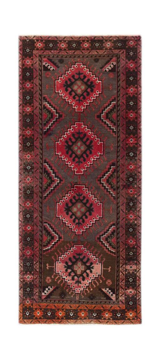 Handmade Afghan Baluch runner rug featuring four geometric medallions on a dark brown background.