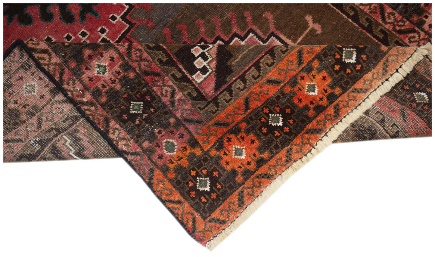 A handmade Afghan Baluch rug featuring geometric patterns in shades of orange, brown, and red.