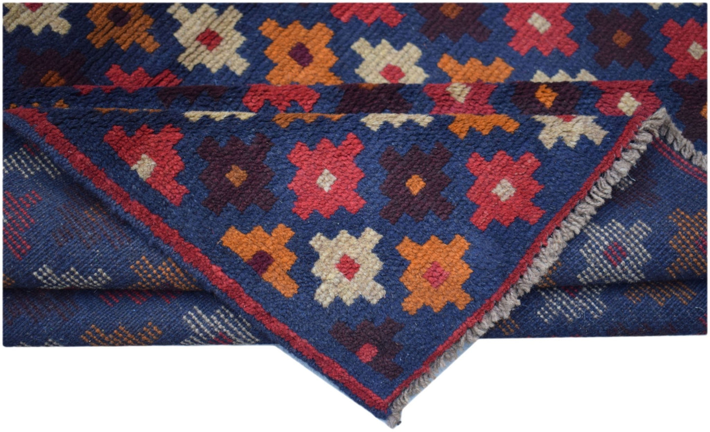Handmade Afghan Baluch rug featuring a geometric floral pattern in red, blue, and ivory wool.