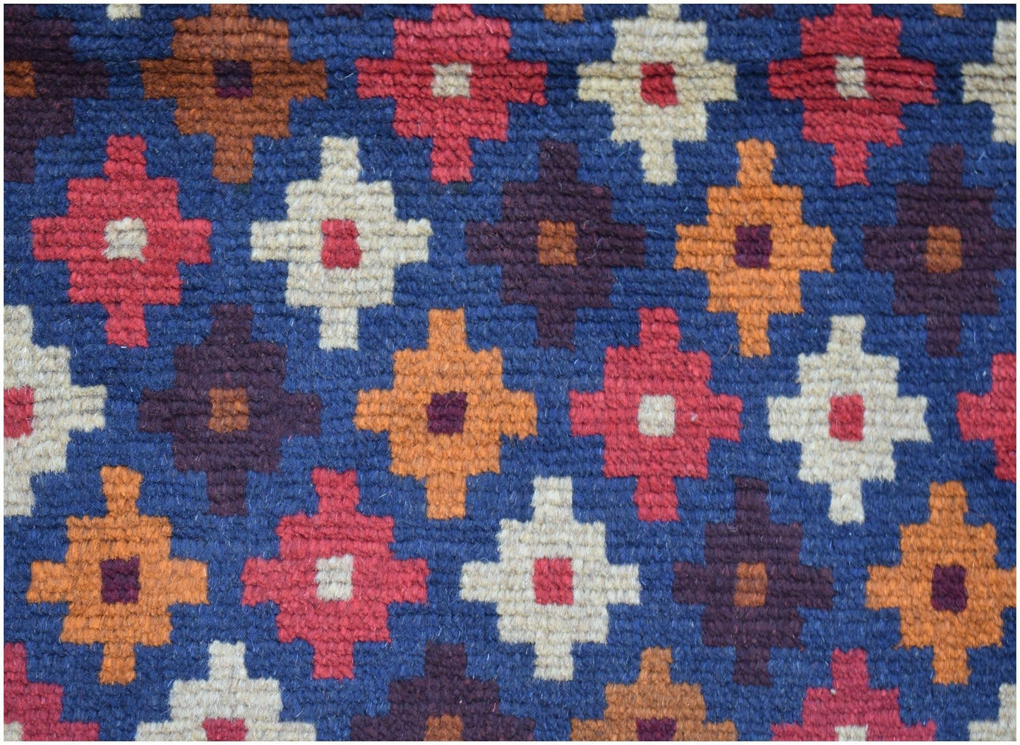 Handmade Afghan Baluch rug featuring a repeating geometric pattern in red, orange, and ivory.