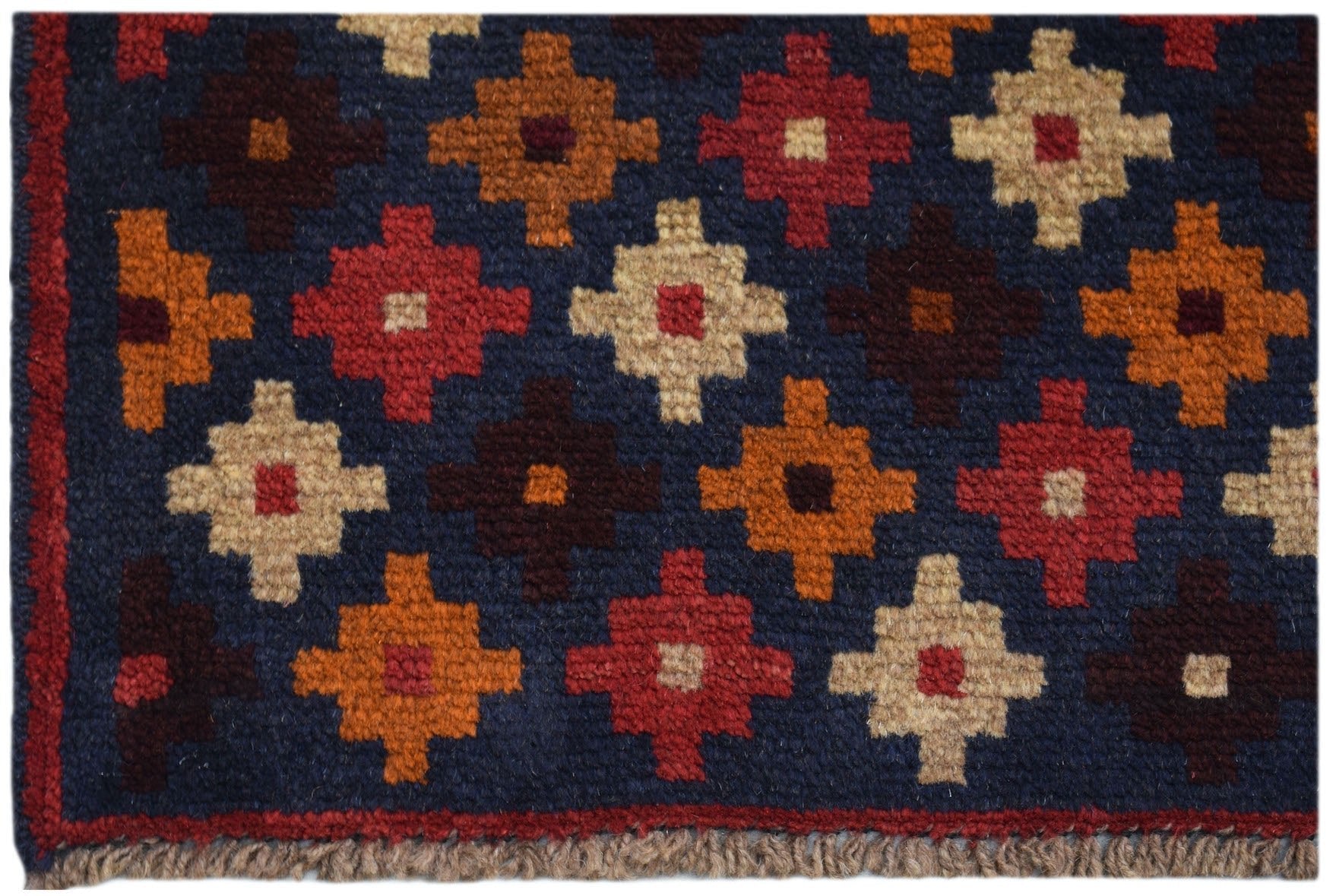 Handmade Afghan Baluch rug featuring a dark blue field with a repeating geometric floral pattern.