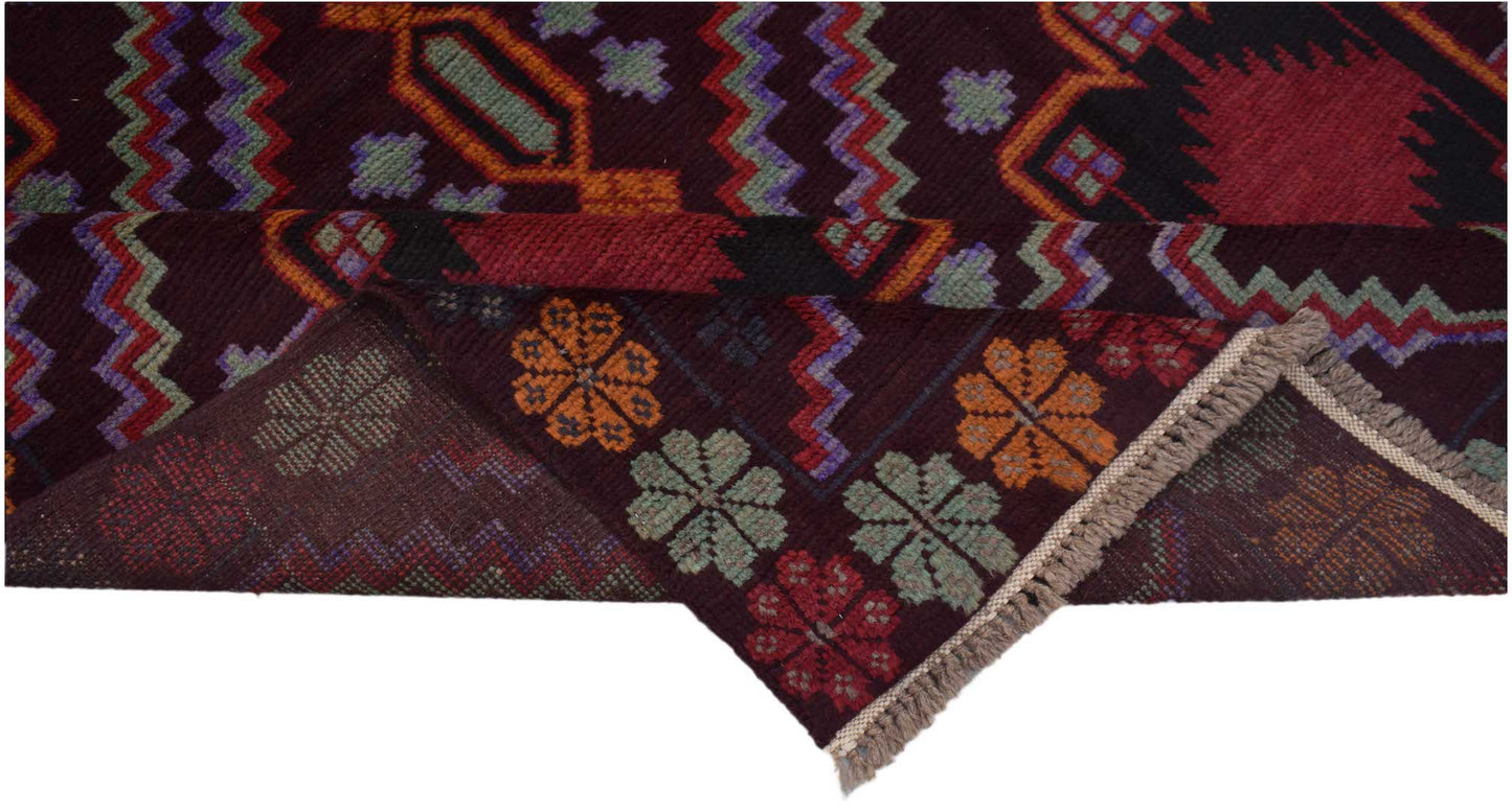 A handmade Afghan Pashm rug featuring geometric patterns and floral motifs in deep red and brown.