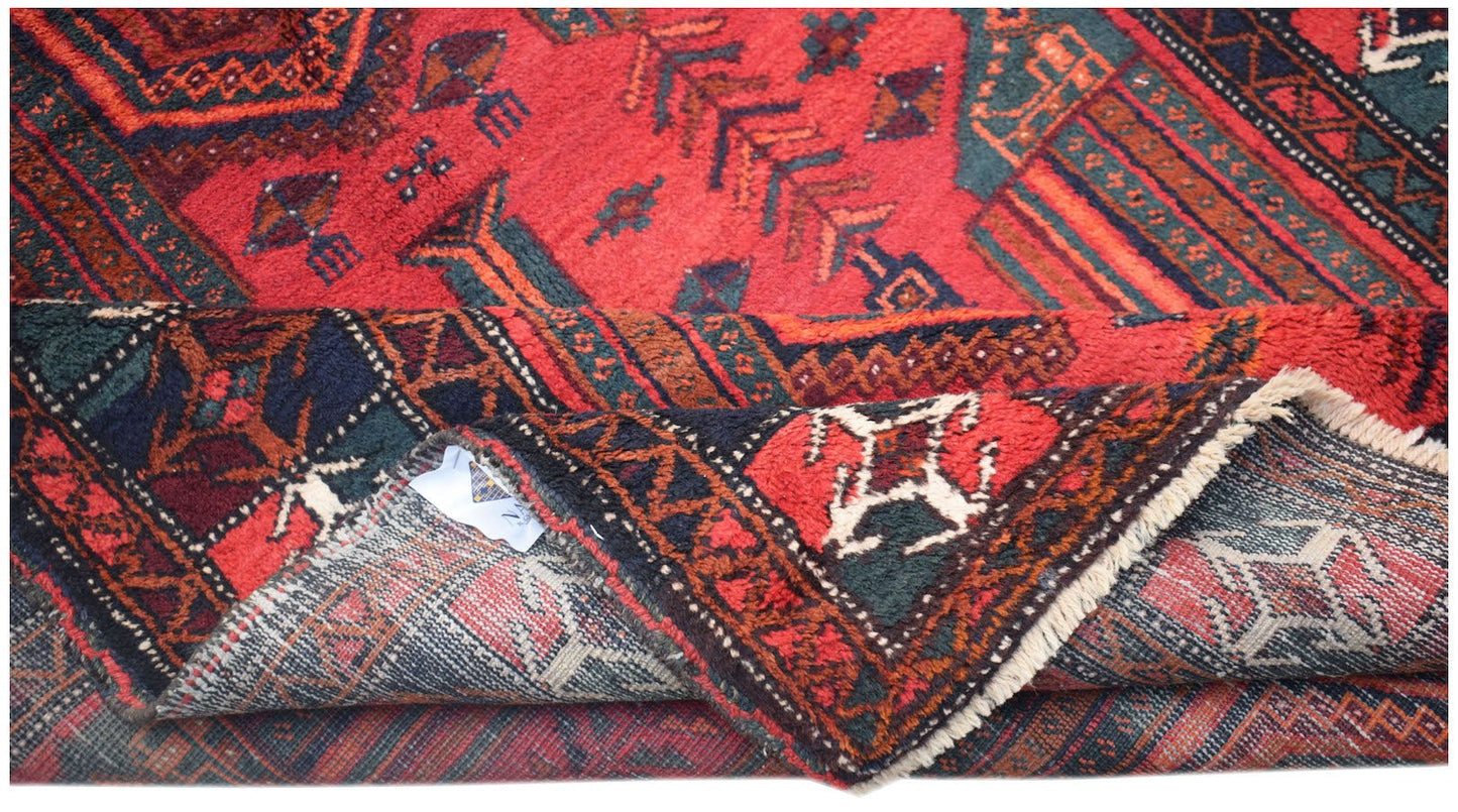 Vintage Afghan Baluch rug with red, green, and blue geometric patterns.