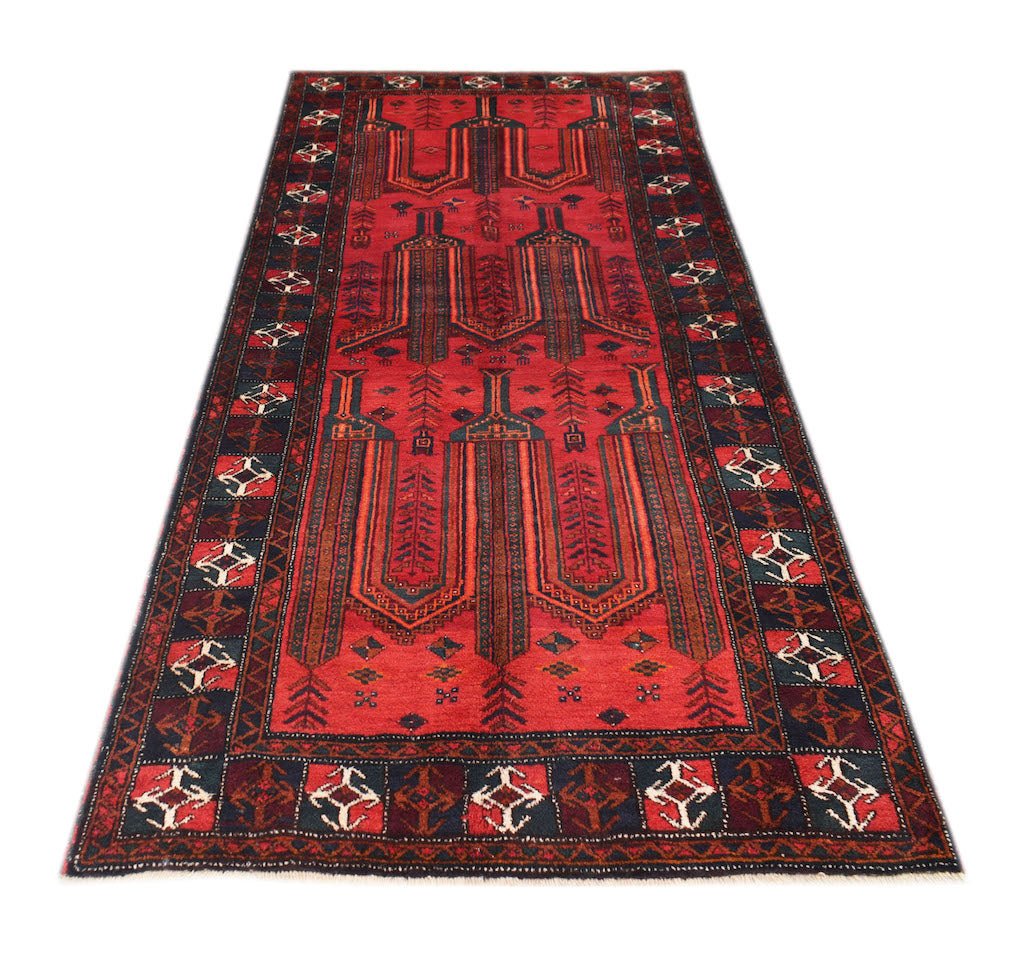 A vintage Afghan Baluch rug featuring a red field with geometric tribal motifs and a dark border.