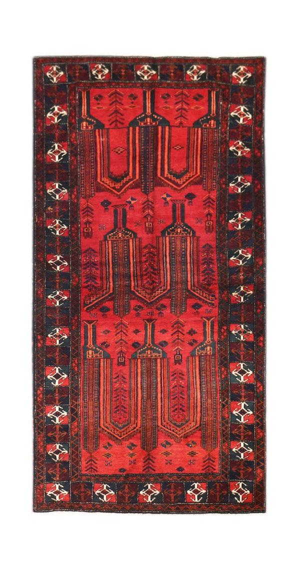 A vintage handmade Afghan Baluch wool rug featuring a red field with geometric tribal motifs.