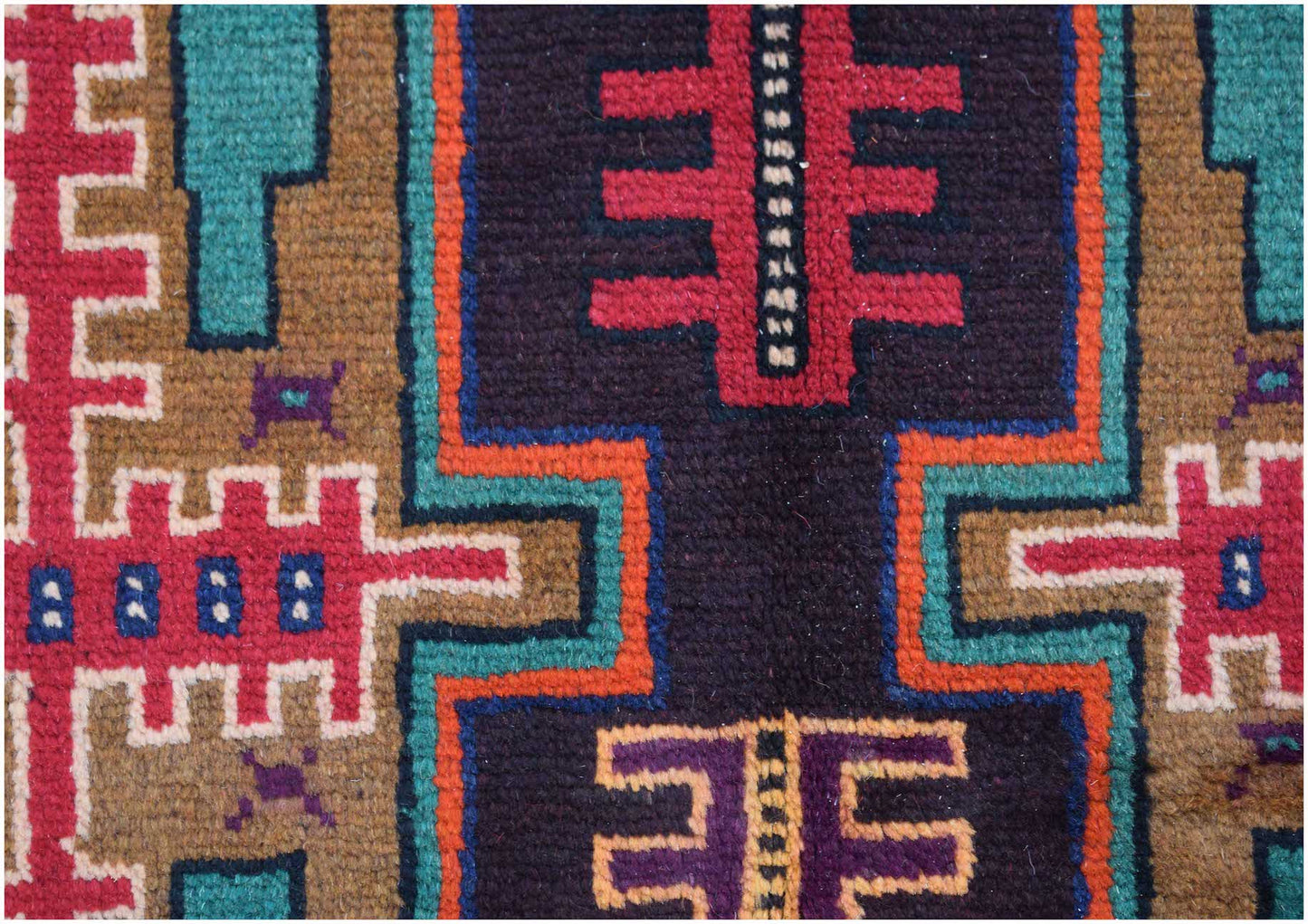 Handmade Afghan Pashm rug featuring geometric tribal patterns in deep red, blue, and brown tones.