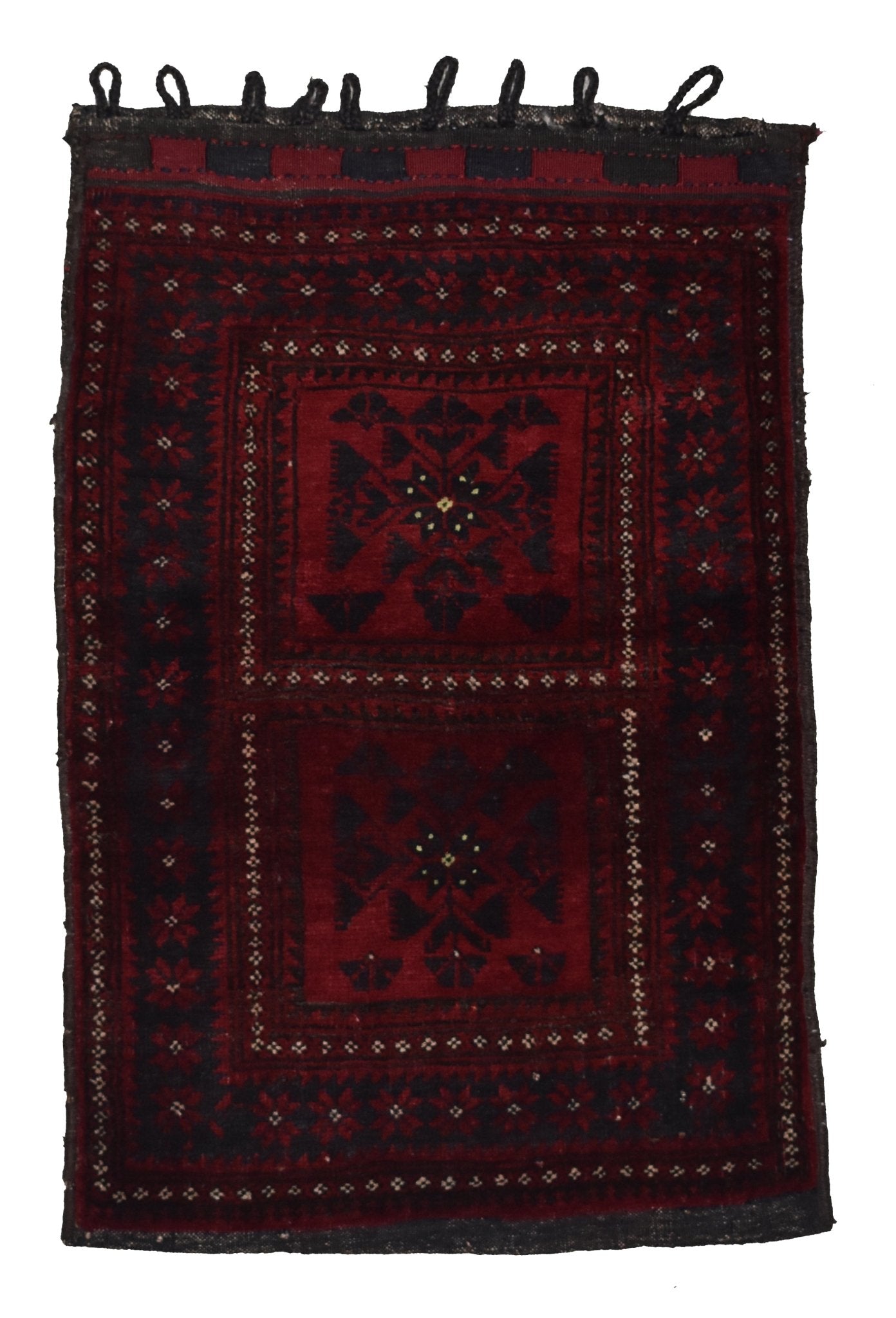 A handmade vintage Afghan Baluch wool cushion featuring a dark red geometric tribal pattern.