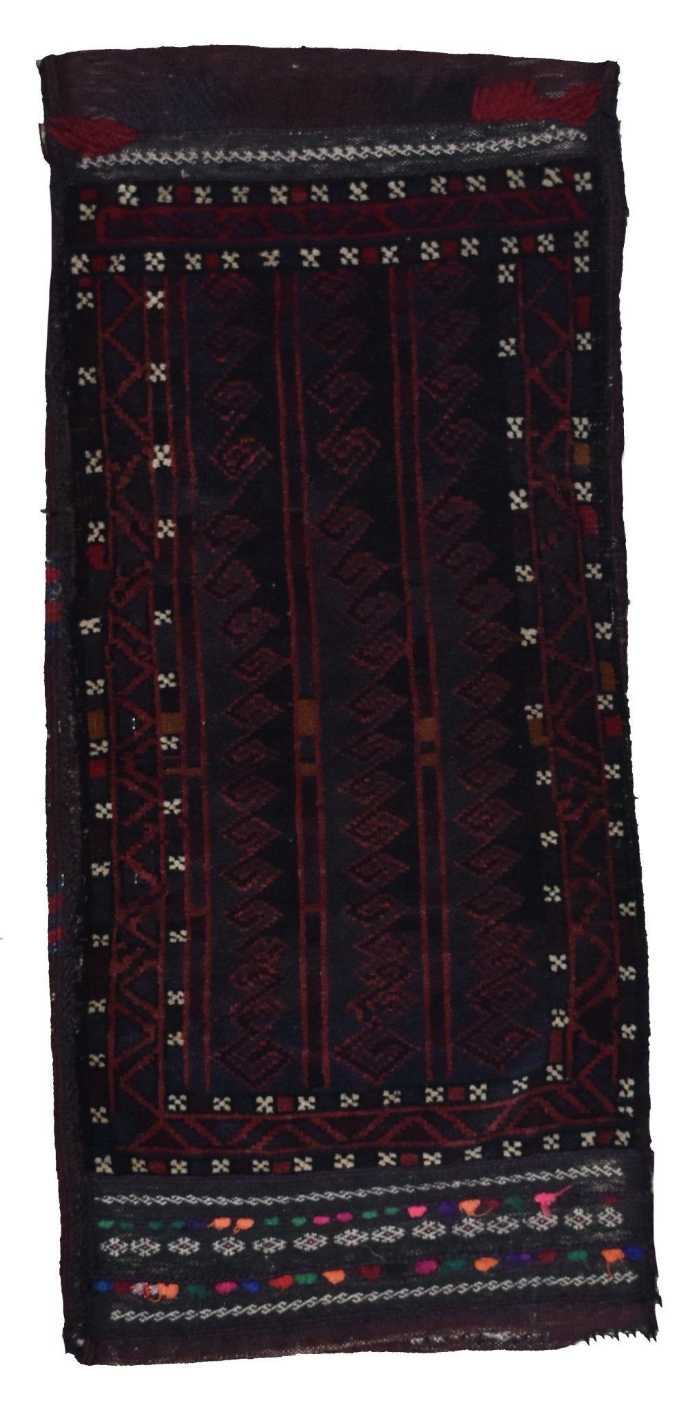 A vintage handmade Afghan Baluch wool cushion featuring dark geometric tribal patterns.