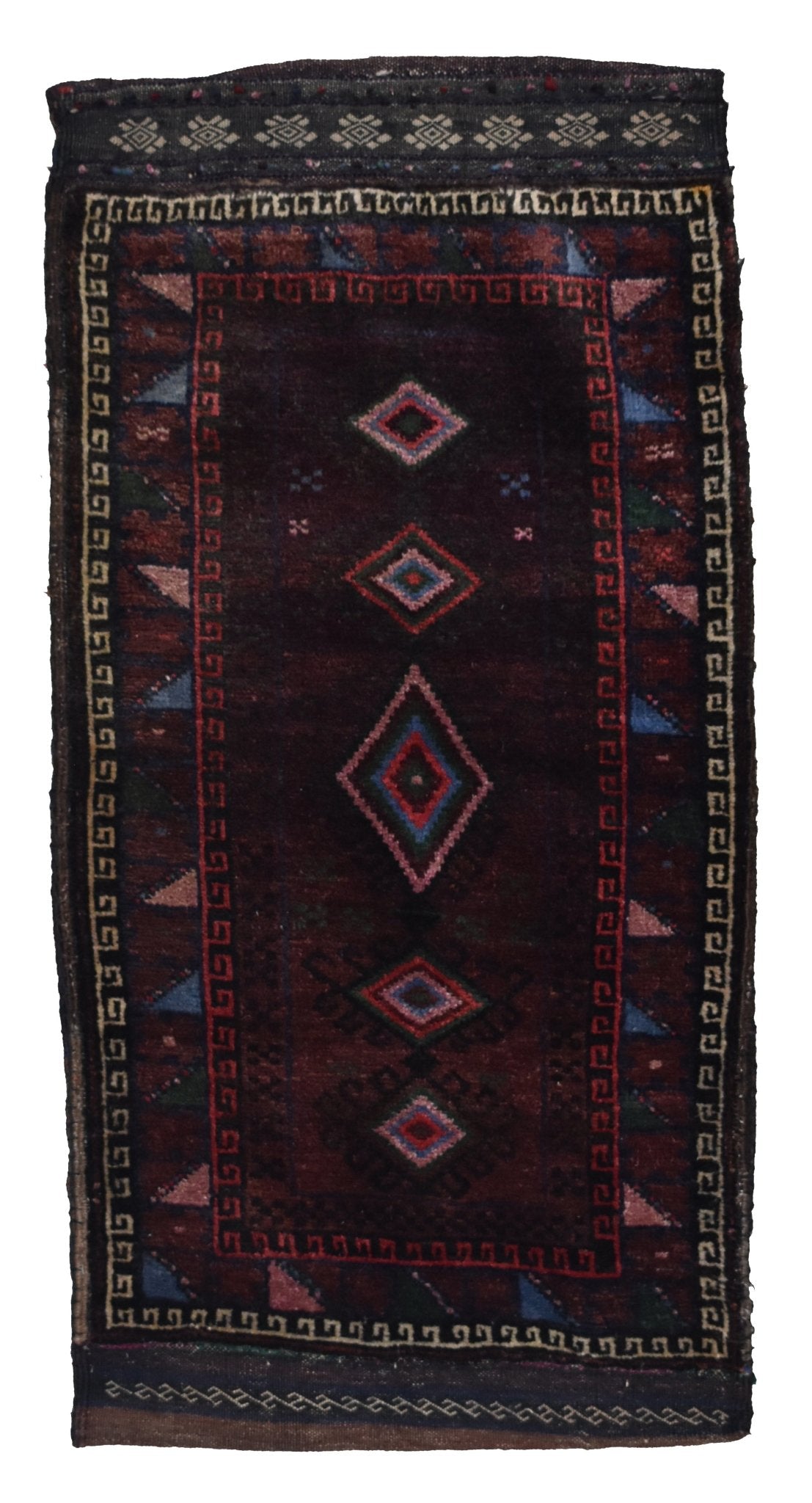 A handmade vintage Afghan Baluch wool cushion featuring a dark red field with geometric diamond motifs.
