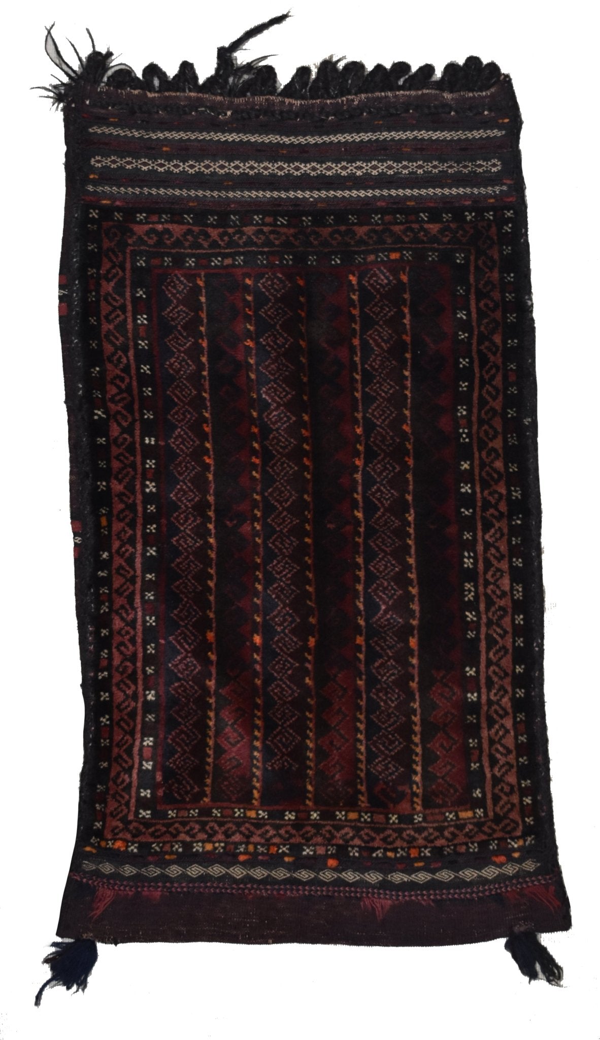 A handmade vintage Afghan Baluch wool cushion featuring dark geometric patterns and fringe ends.