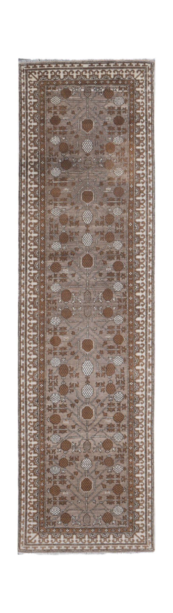 An Afghan Chobi runner rug featuring a repeating geometric tree motif in natural wool tones.