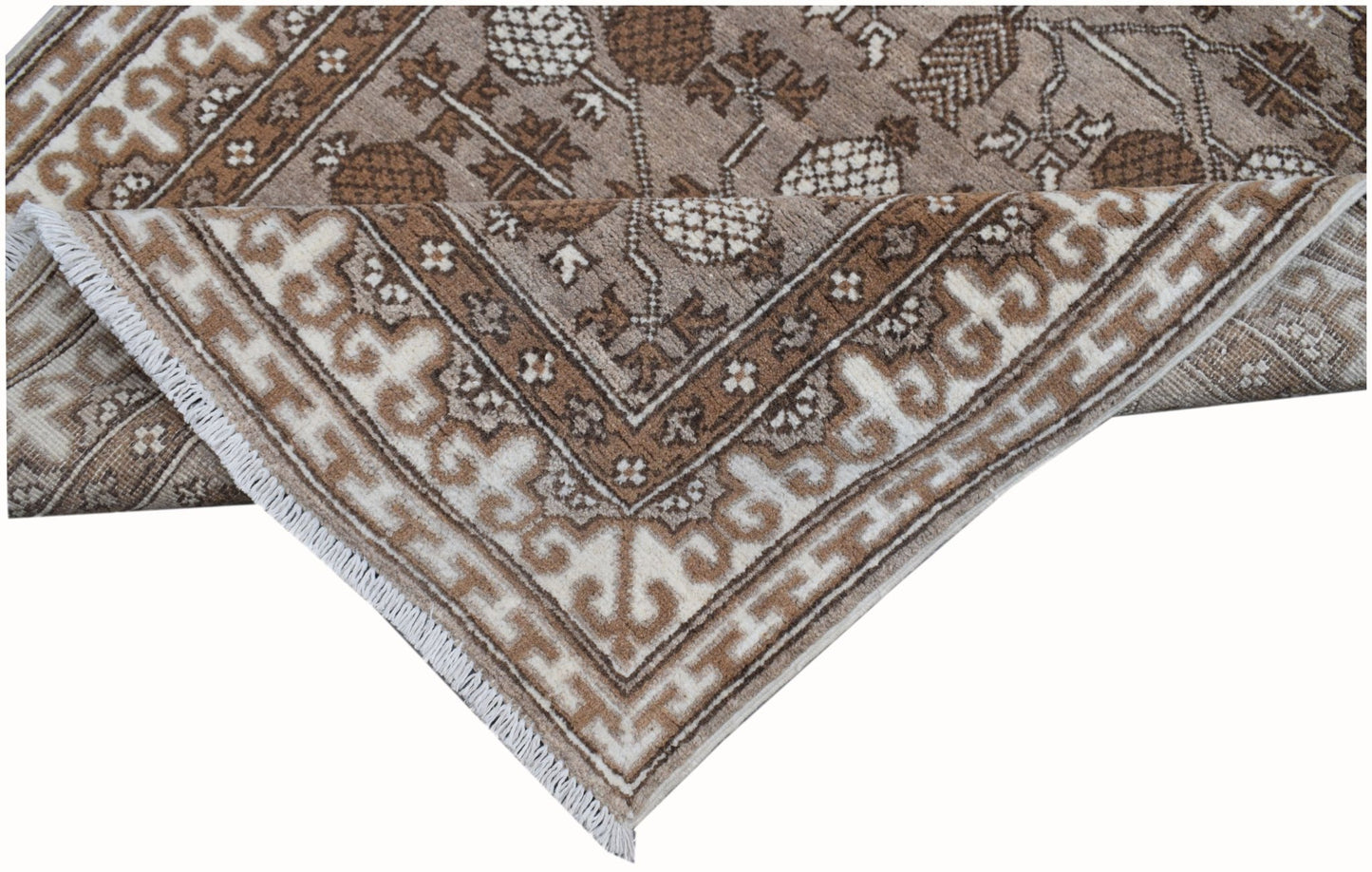 A handmade Afghan Chobi runner rug featuring a brown and cream geometric floral pattern.