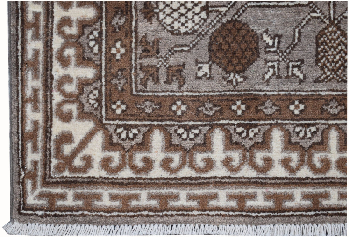 A handmade Afghan Chobi runner featuring a brown and cream geometric Khotan pattern.