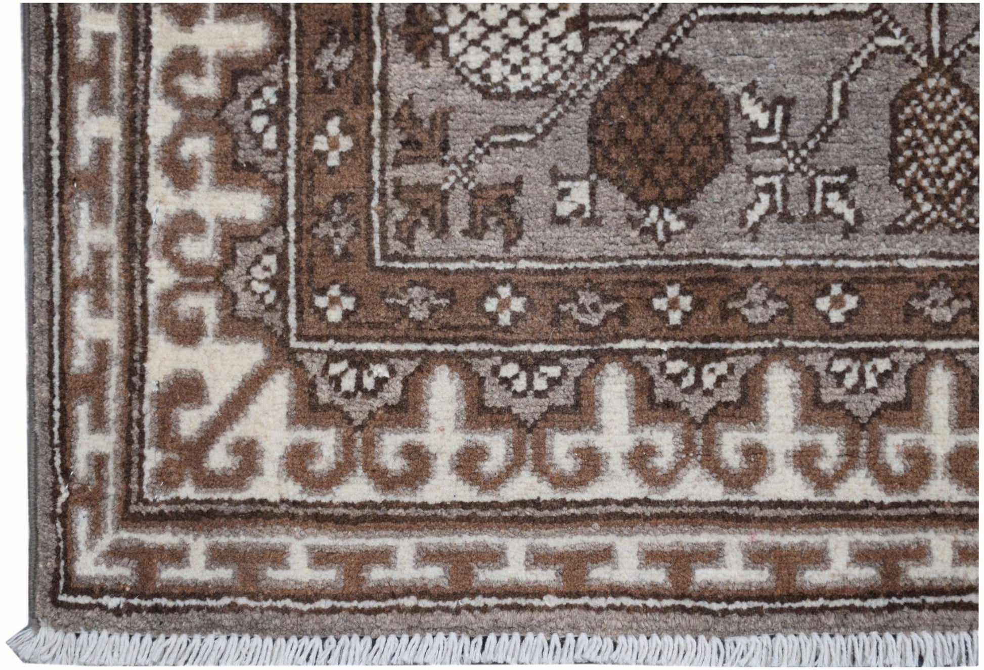 A handmade Afghan Chobi runner featuring a brown and cream geometric Khotan pattern.