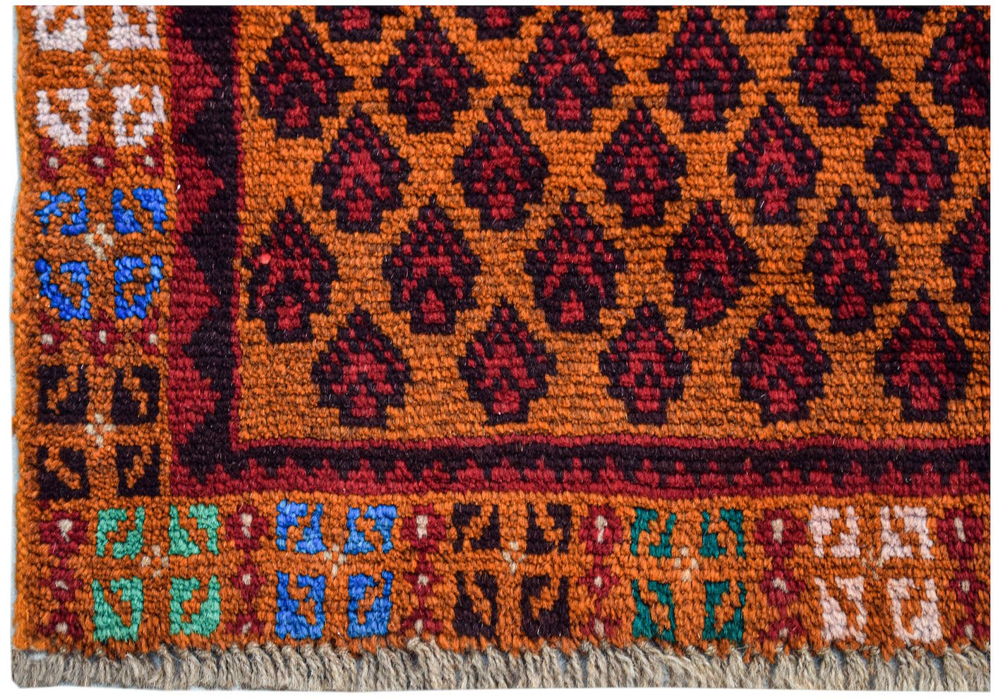 Handmade Afghan Pashm rug featuring a repeating dark red floral pattern on an orange background.