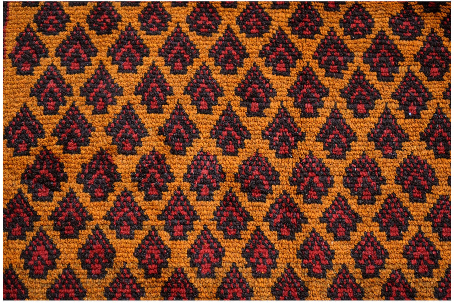 Handmade Afghan Pashm rug featuring a repeating dark red and brown floral pattern on an orange base.