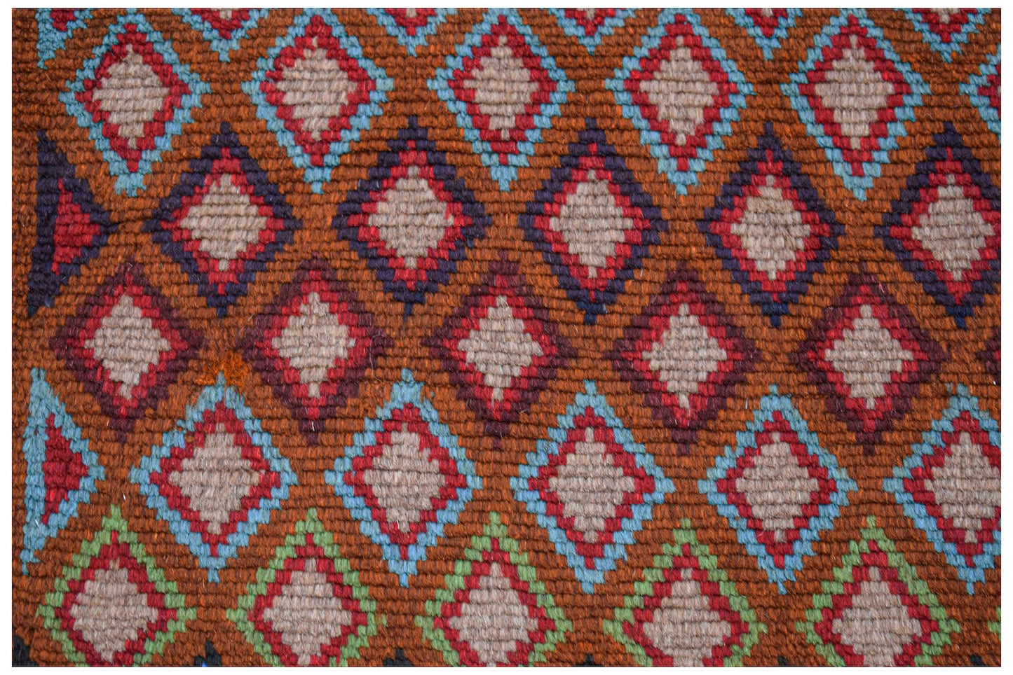 Handmade Afghan Pashm rug featuring a repeating diamond pattern in shades of red, blue, and brown.