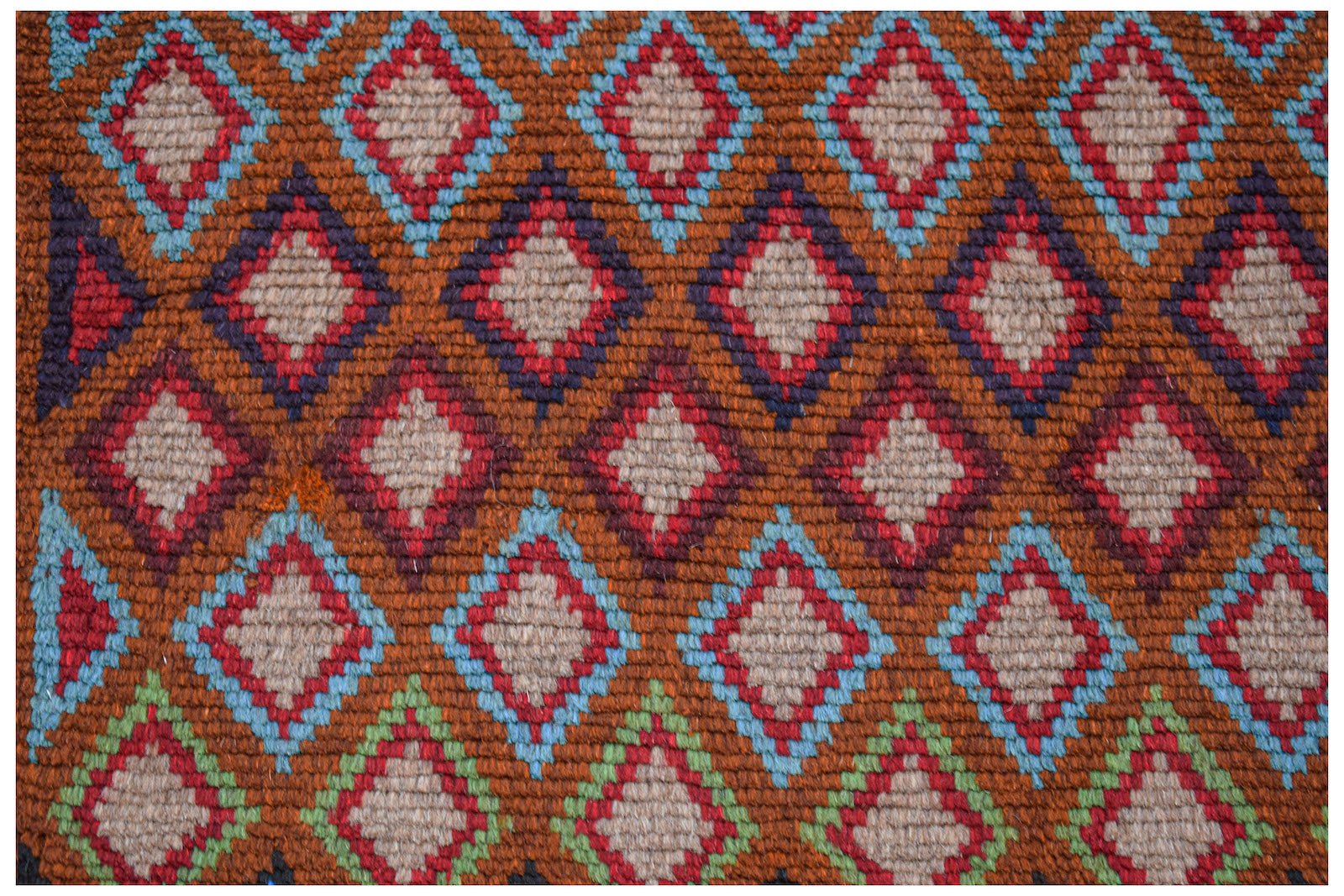 Handmade Afghan Pashm rug featuring a repeating diamond pattern in shades of red, blue, and brown.