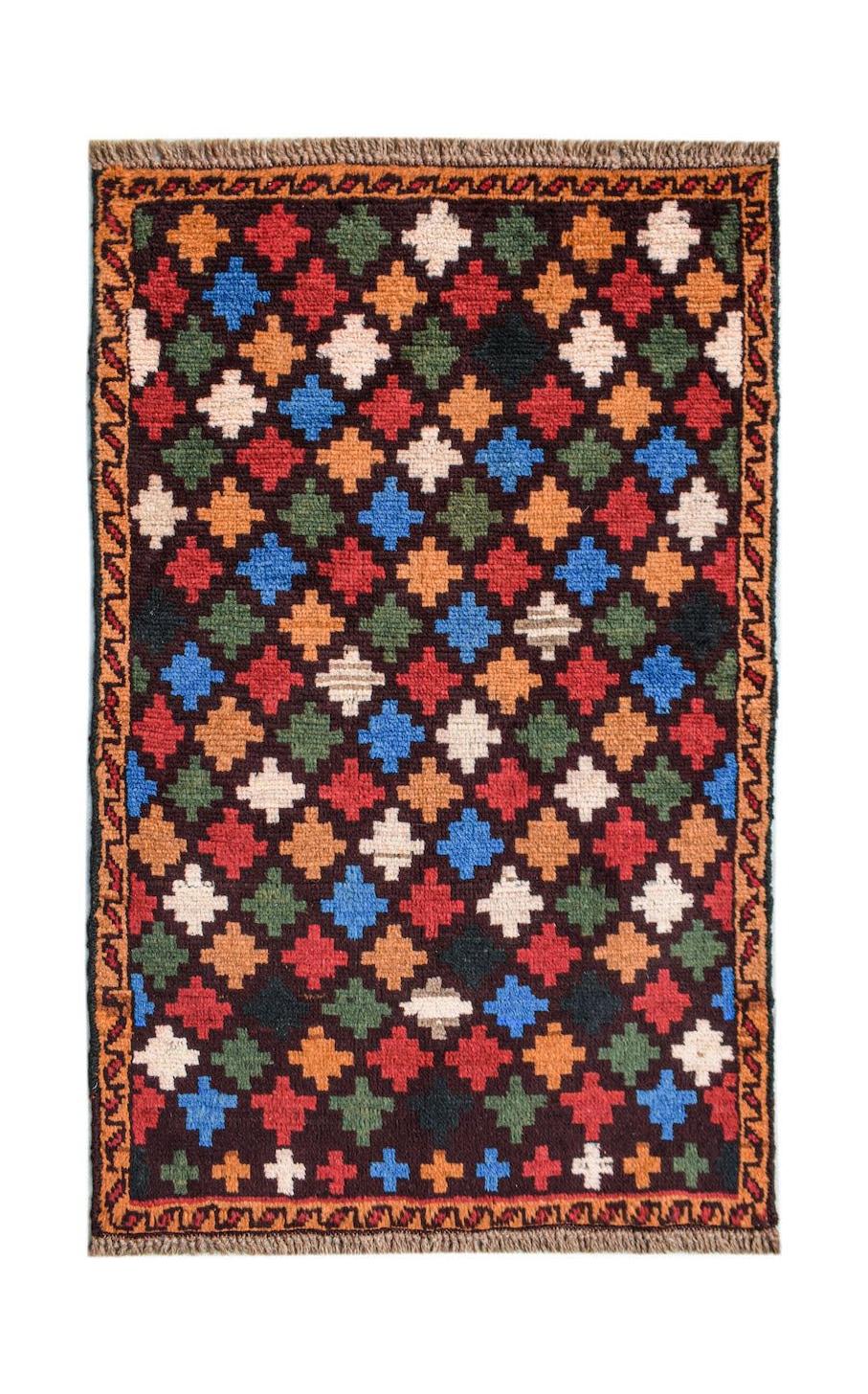 Handmade Afghan Pashm rug featuring a repeating geometric pattern in vibrant colors on a dark base.