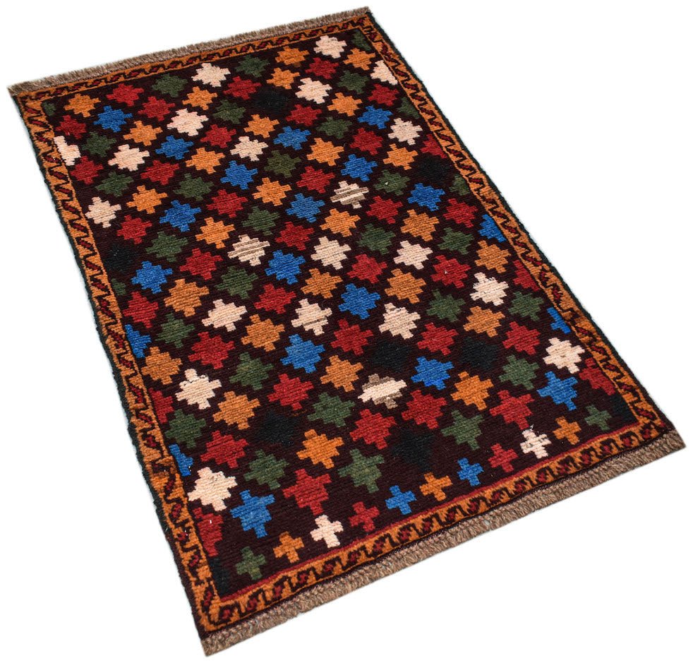 A handmade Afghan Pashm rug featuring a repeating pattern of colorful geometric crosses.