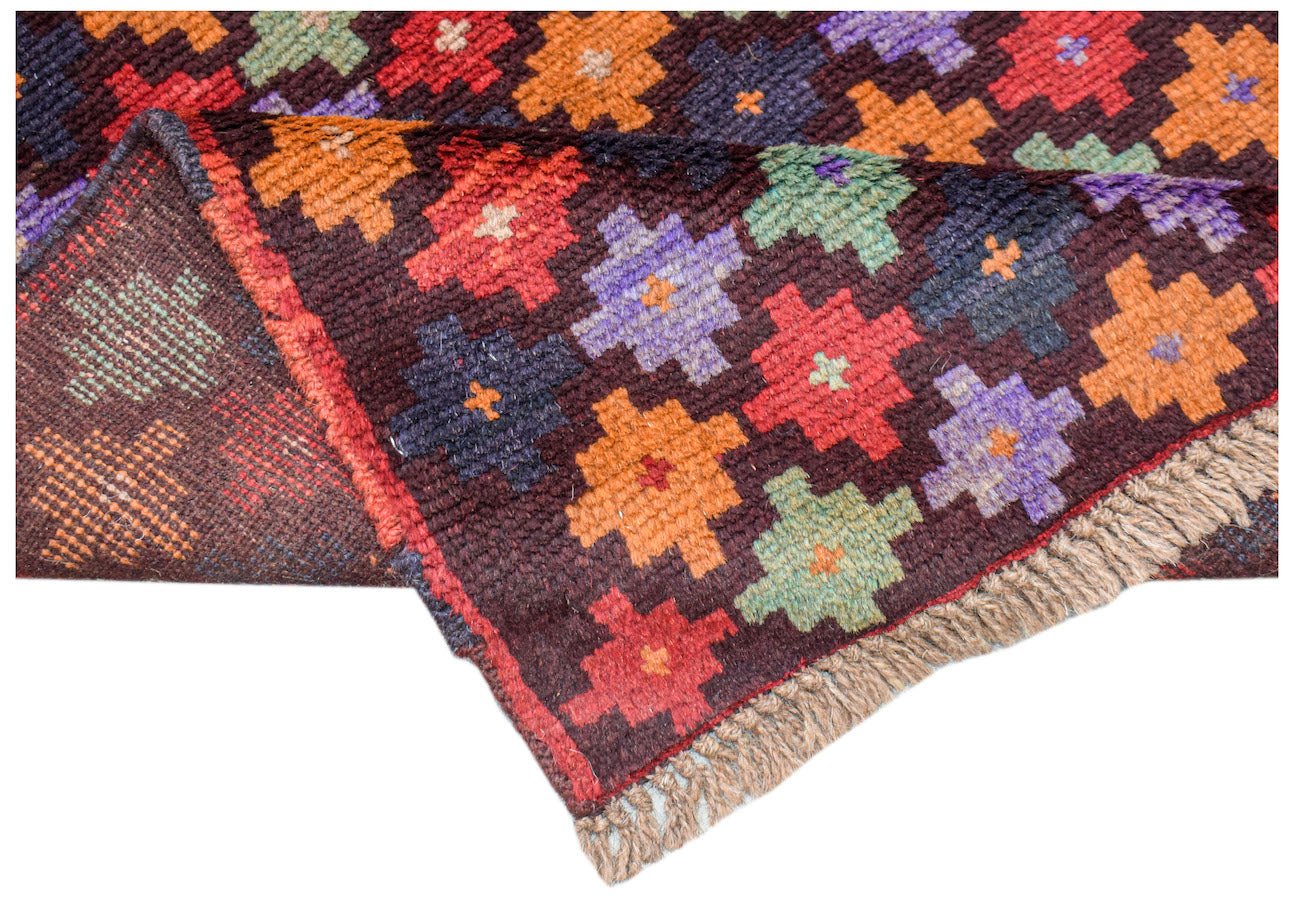 A handmade Afghan Pashm rug featuring a dark brown field with colorful geometric floral motifs.