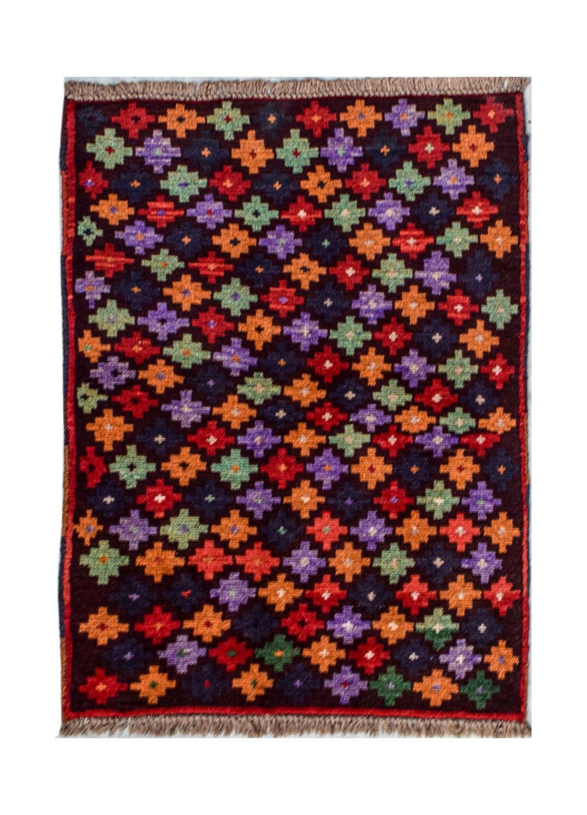 Handmade Afghan Pashm rug featuring a repeating geometric pattern in vibrant colors on a dark base.
