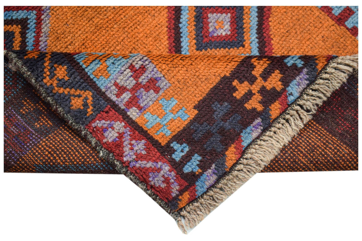 A handmade Afghan Pashm rug featuring geometric tribal patterns in orange, blue, and dark brown.