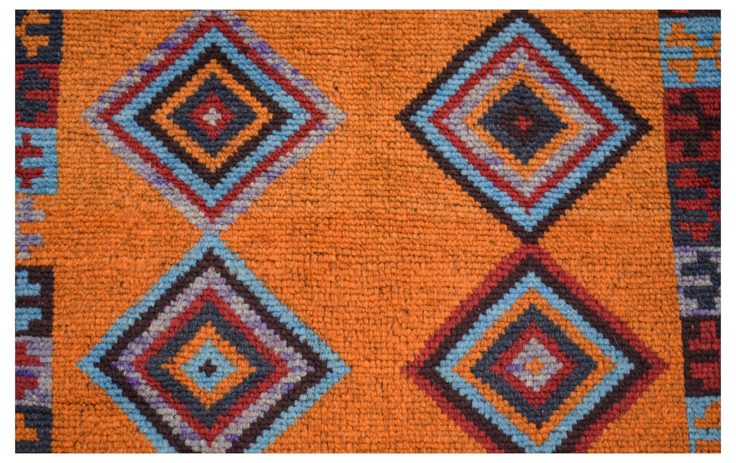 Handmade Afghan wool rug featuring a vibrant orange field with repeating geometric diamond motifs.