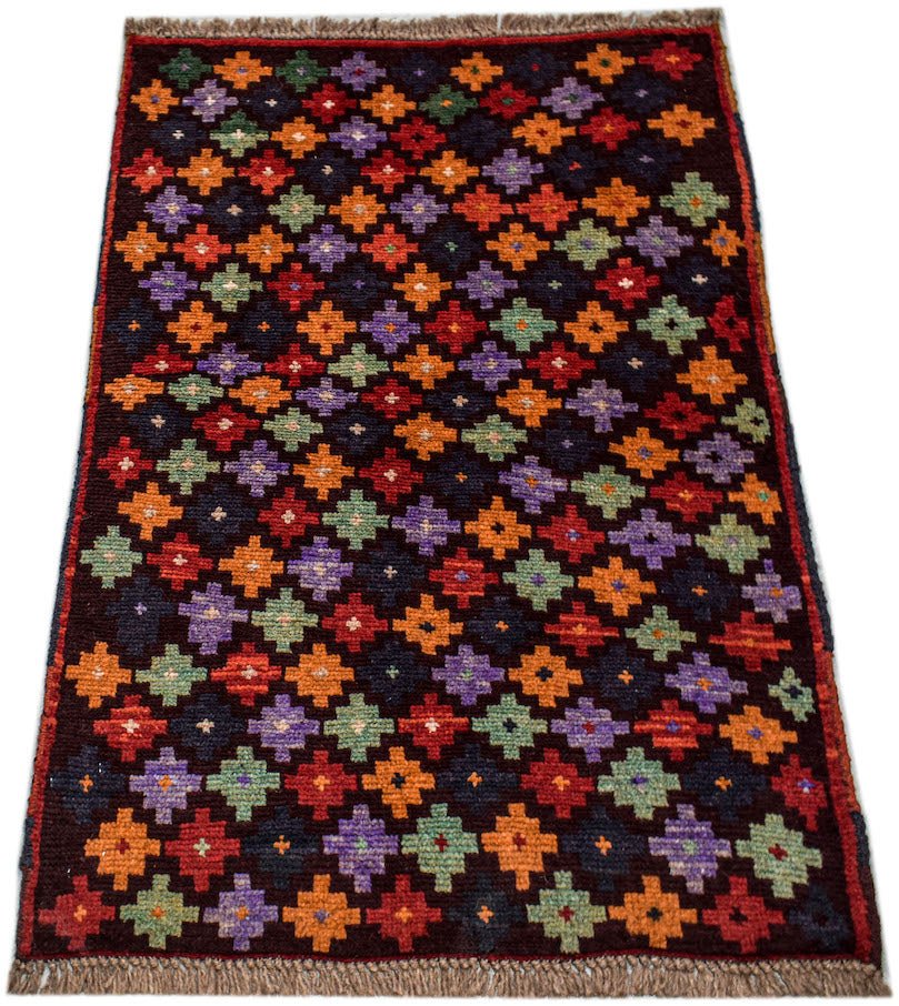 Handmade Afghan Pashm rug featuring a repeating geometric diamond pattern in vibrant colors.