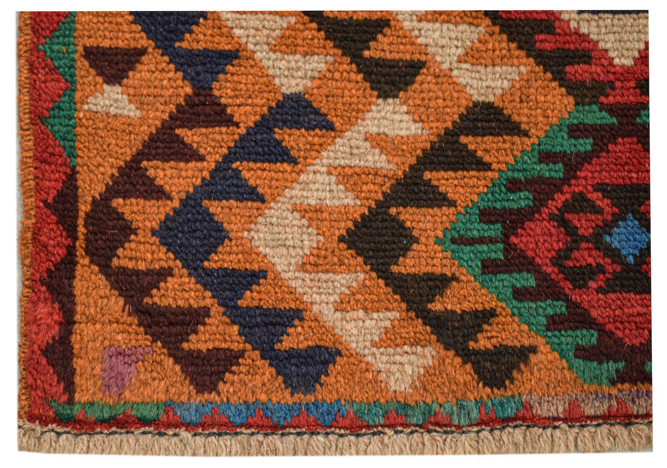 Close-up of a handmade Afghan wool rug with a diamond pattern in orange, blue, and tan.