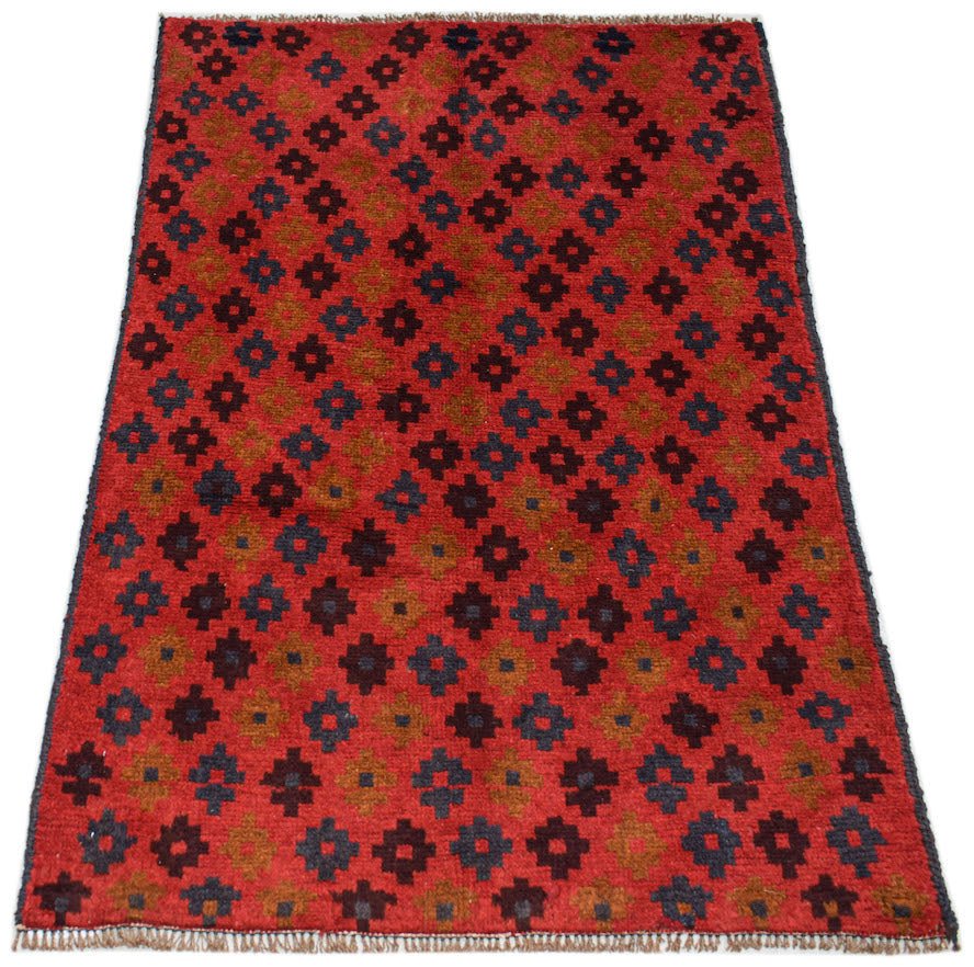 Handmade Afghan Pashm rug featuring a repeating geometric pattern in red, brown, and blue.