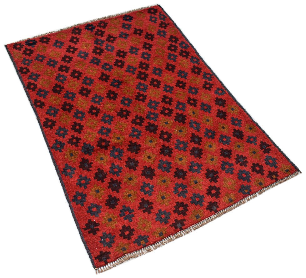 Handmade Afghan Pashm rug featuring a repeating geometric floral pattern in red, blue, and brown.