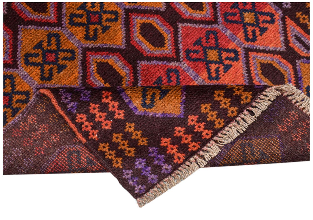 Handmade Afghan Pashm rug featuring a geometric pattern in shades of brown, orange, and blue.