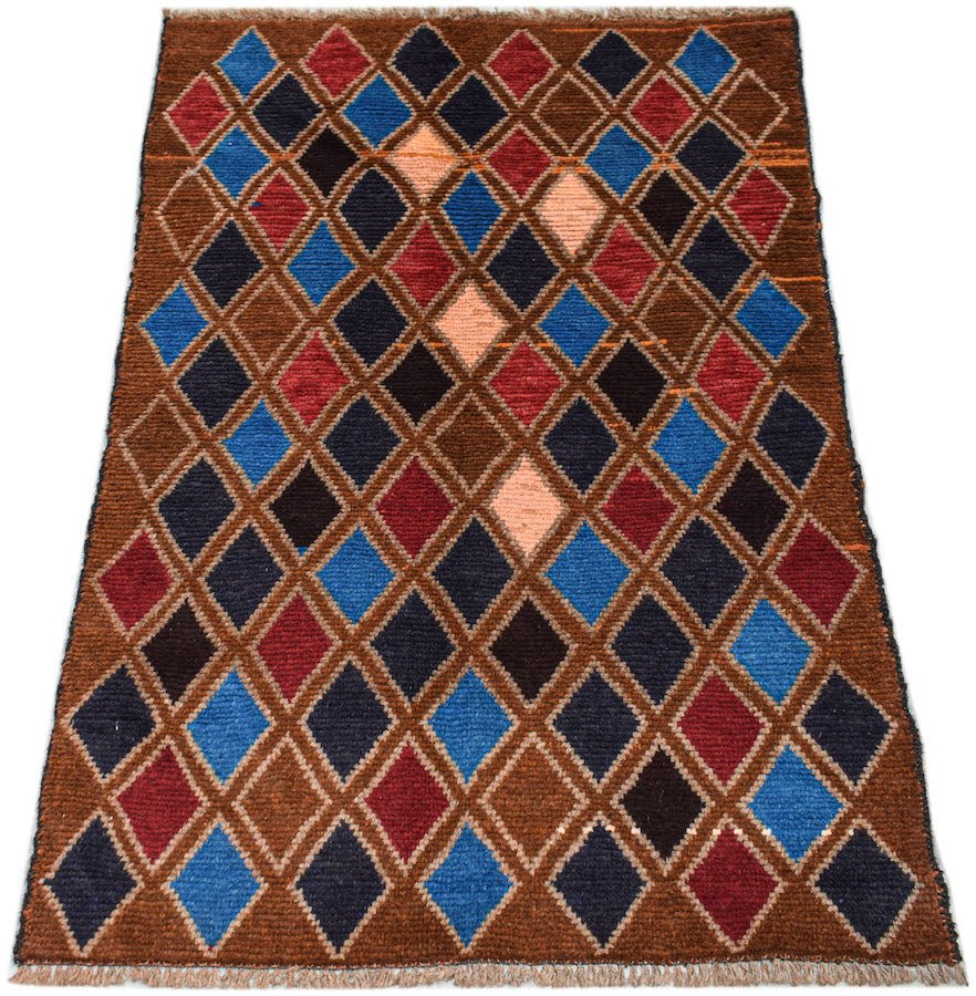 Handmade Afghan Pashm rug featuring a repeating diamond pattern in shades of red, blue, and brown.
